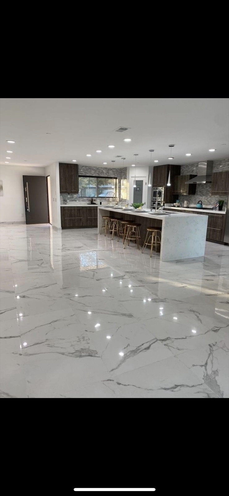 Custom open-concept kitchen remodel by RL Remodeling — marble waterfall island, dark wood cabinetry, mosaic backsplash, in a western Chicago suburb home.